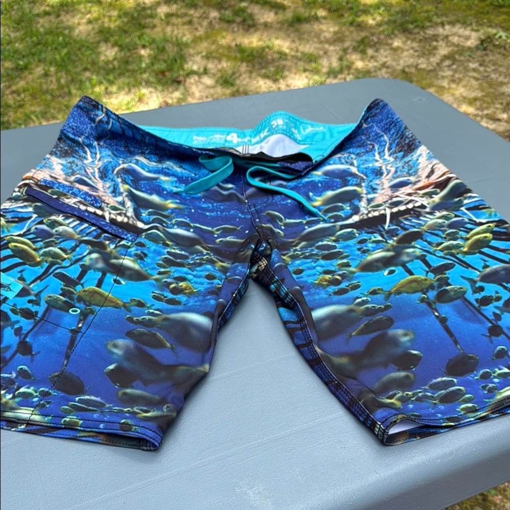 Pelagic Blue and Green Board Shorts with Wave-Inspired Design